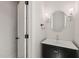 Stylish bathroom with vanity, a round mirror and modern lighting at 380 Pilot Ridge Rd, Zebulon, NC 27597