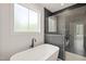 Modern bathroom features a soaking tub, sleek black fixtures and a luxurious tiled shower at 380 Pilot Ridge Rd, Zebulon, NC 27597