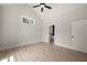 Bright bedroom boasts a ceiling fan, light hardwood floors, and plenty of natural light at 380 Pilot Ridge Rd, Zebulon, NC 27597