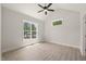 Bright bedroom with a ceiling fan, natural light, and wood-look flooring at 380 Pilot Ridge Rd, Zebulon, NC 27597