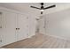 Bright bedroom features a ceiling fan, closet, and wood-look flooring at 380 Pilot Ridge Rd, Zebulon, NC 27597