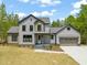 Charming two-story home featuring a two-car garage, manicured lawn, and stylish gray siding at 380 Pilot Ridge Rd, Zebulon, NC 27597