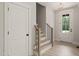 Bright foyer featuring wood stairs with black iron spindles and a glass paneled front door at 380 Pilot Ridge Rd, Zebulon, NC 27597