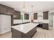 Modern kitchen with a large island, stainless steel appliances, and a tiled backsplash at 380 Pilot Ridge Rd, Zebulon, NC 27597