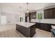 Open concept kitchen with large island, stainless appliances, and view to the living room at 380 Pilot Ridge Rd, Zebulon, NC 27597