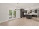 Open kitchen with gray cabinets, stainless appliances, a center island, and adjacent dining area at 380 Pilot Ridge Rd, Zebulon, NC 27597