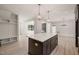 Spacious kitchen island with view of breakfast room, living room and fireplace at 380 Pilot Ridge Rd, Zebulon, NC 27597