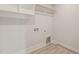 Bright and airy laundry room with overhead shelving and modern design at 380 Pilot Ridge Rd, Zebulon, NC 27597