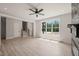 Spacious living room featuring natural light, wood-look floors, and a fireplace with a striking black brick surround at 380 Pilot Ridge Rd, Zebulon, NC 27597