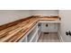 Walk-in pantry with custom shelving, butcher block countertop and modern design elements at 380 Pilot Ridge Rd, Zebulon, NC 27597