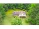 An aerial perspective of a charming home with a lush lawn and surrounding trees at 4006 Daniel Rd, Durham, NC 27703