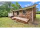 Brick home featuring a back patio, siding, and a well-maintained lawn for outdoor enjoyment at 4006 Daniel Rd, Durham, NC 27703