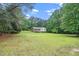 A lush lawn and mature trees frame a beautiful home exterior at 4006 Daniel Rd, Durham, NC 27703