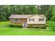 Charming split-level home with a brick facade and manicured lawn surrounded by mature trees at 4006 Daniel Rd, Durham, NC 27703