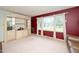 Bright living room with large windows, plush carpet, and classic built-in shelving, creating a warm, inviting space at 4006 Daniel Rd, Durham, NC 27703
