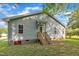 Backyard view of home with stairs, grass, and tidy landscaping at 407 Collier St, Smithfield, NC 27577