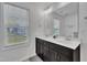 Bright bathroom with a double sink vanity, modern fixtures, and a large window at 407 Collier St, Smithfield, NC 27577