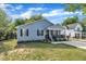 Street view of a charming single-story house with light-blue siding and a well-kept lawn and plantings at 407 Collier St, Smithfield, NC 27577