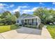 Angle view of a cozy house with beautiful lawn, a covered porch, and a concrete driveway at 407 Collier St, Smithfield, NC 27577