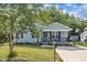 Well-kept, light blue home with black shutters, covered porch and an easy access concrete driveway at 407 Collier St, Smithfield, NC 27577