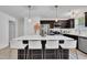 Spacious kitchen features a large island with bar stool seating and stainless steel appliances and dark cabinets at 407 Collier St, Smithfield, NC 27577