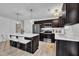 Modern kitchen featuring a large island with bar stool seating, stainless steel appliances, and dark cabinetry at 407 Collier St, Smithfield, NC 27577