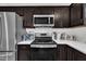 This kitchen has stainless steel appliances, quartz countertops, and dark wood cabinets at 407 Collier St, Smithfield, NC 27577