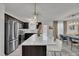 Bright and modern kitchen with a large island, bar seating, stainless steel appliances, and dark wood cabinets at 407 Collier St, Smithfield, NC 27577
