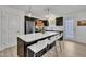 Modern kitchen features a large island with white countertop and bar stool seating, along with stainless steel appliances at 407 Collier St, Smithfield, NC 27577