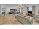 Open-concept living area featuring dining area, bar seating, dark cabinets and wooden floors at 407 Collier St, Smithfield, NC 27577