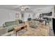 Spacious open concept living area features sleek wooden floors, ceiling fan, and views of the kitchen at 407 Collier St, Smithfield, NC 27577