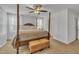 Spacious main bedroom boasts a four poster bed, plush carpeting, and bright natural light at 407 Collier St, Smithfield, NC 27577