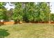 Large backyard with lush green grass and a wooden fence at 4109 Huckleberry Dr, Raleigh, NC 27612