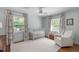 Bedroom room with white carpet, a crib by the window, and a recliner for comfort and relaxation at 4109 Huckleberry Dr, Raleigh, NC 27612