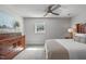 Comfortable bedroom features a large window, carpet, ceiling fan, and wooden dresser at 4109 Huckleberry Dr, Raleigh, NC 27612