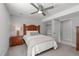 Cozy bedroom with a ceiling fan, carpet, wood-frame bed, and a convenient closet at 4109 Huckleberry Dr, Raleigh, NC 27612