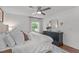 Bright bedroom featuring a ceiling fan, a window with natural light, and a dresser with a decorative mirror at 4109 Huckleberry Dr, Raleigh, NC 27612