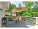 Outdoor deck area with an umbrella, seating, and grill at 4109 Huckleberry Dr, Raleigh, NC 27612