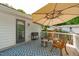 Outdoor deck features a door to the interior, an umbrella, seating, and grill at 4109 Huckleberry Dr, Raleigh, NC 27612