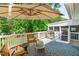 An outdoor deck area with seating, grill, and umbrella at 4109 Huckleberry Dr, Raleigh, NC 27612