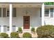 Close-up of front door highlighting its craftsman style, with potted plants adorning the entrance at 4109 Huckleberry Dr, Raleigh, NC 27612
