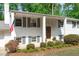 Welcoming front entry with white columns, gray shutters, and a classic wood door at 4109 Huckleberry Dr, Raleigh, NC 27612