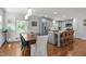 A spacious kitchen and dining area with an island, stainless appliances, and hardwood floors at 4109 Huckleberry Dr, Raleigh, NC 27612