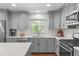 Modern kitchen with stainless steel appliances, light countertops, and undermount sink at 4109 Huckleberry Dr, Raleigh, NC 27612