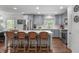 Open kitchen featuring stainless steel appliances, an island with seating, and hardwood floors at 4109 Huckleberry Dr, Raleigh, NC 27612