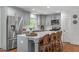 Modern kitchen features stainless steel appliances, a breakfast bar, and light countertops at 4109 Huckleberry Dr, Raleigh, NC 27612