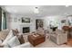 Inviting living room featuring a fireplace, stylish furnishings, and seamless flow to dining area at 4109 Huckleberry Dr, Raleigh, NC 27612