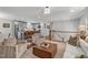Open concept living room flows into a modern kitchen with seating, hardwood floors, and natural light at 4109 Huckleberry Dr, Raleigh, NC 27612