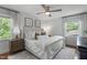 Bright bedroom with large windows, ceiling fan, and neutral decor at 4109 Huckleberry Dr, Raleigh, NC 27612