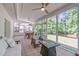Spacious screened porch with dining area, comfortable seating, a ceiling fan, and a view of the backyard at 4109 Huckleberry Dr, Raleigh, NC 27612